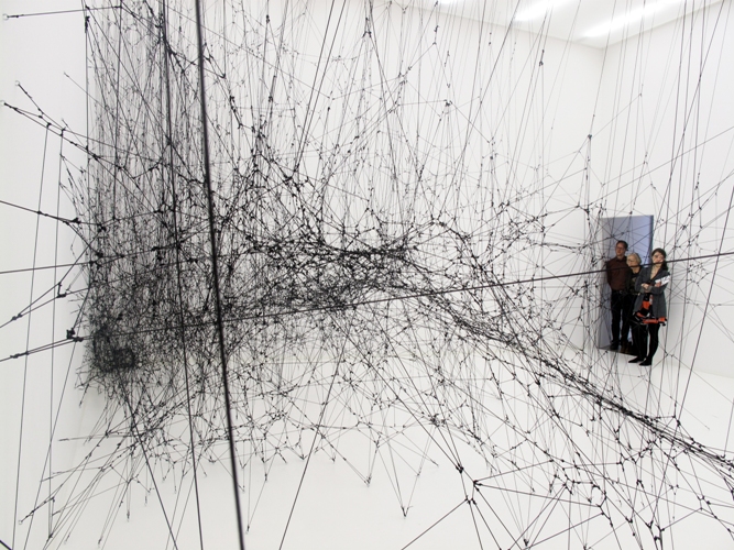 Tomás Saraceno, 14 Billions (Working Title), 2010. Elastic black rope, hooks, 8,330 x 7,630 x 5,000 mm. Courtesy of Bonniers Konsthall, Stockholm, Sweden.